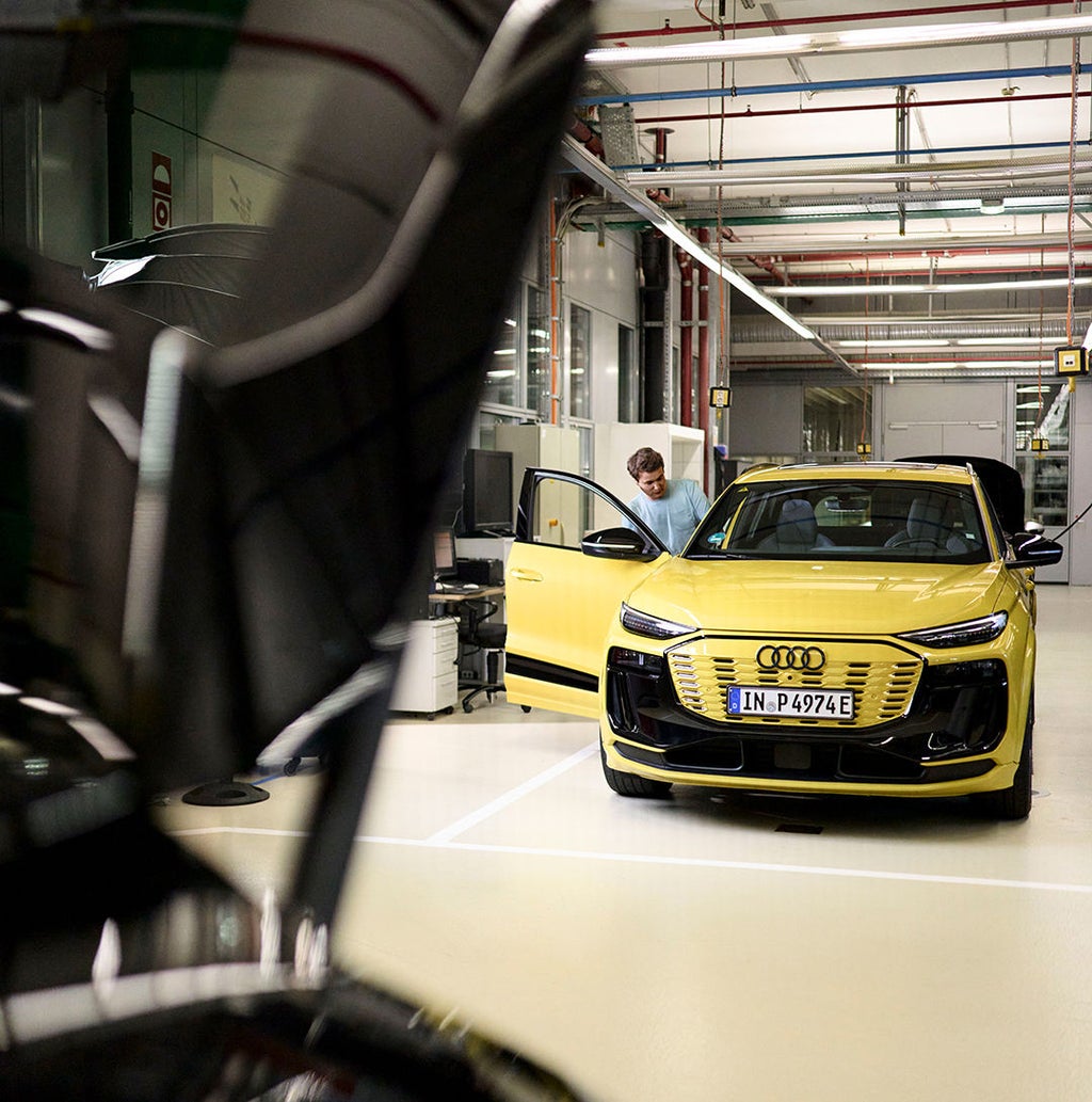 Jan Totz gets into a yellow Audi in a workshop