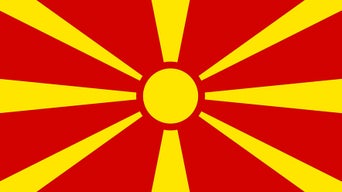 Macedonian flag, red with a yellow sun and eight yellow rays pointing in all directions.