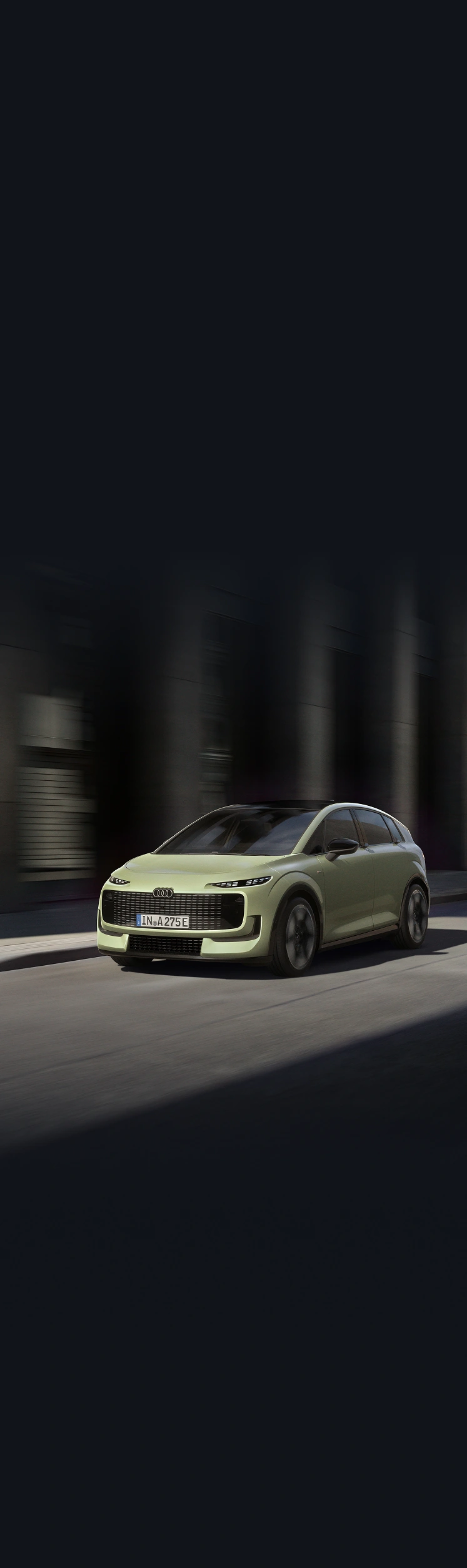 Parallax image of an Audi A2 e-tron electric hatchback driving on a city street at dusk