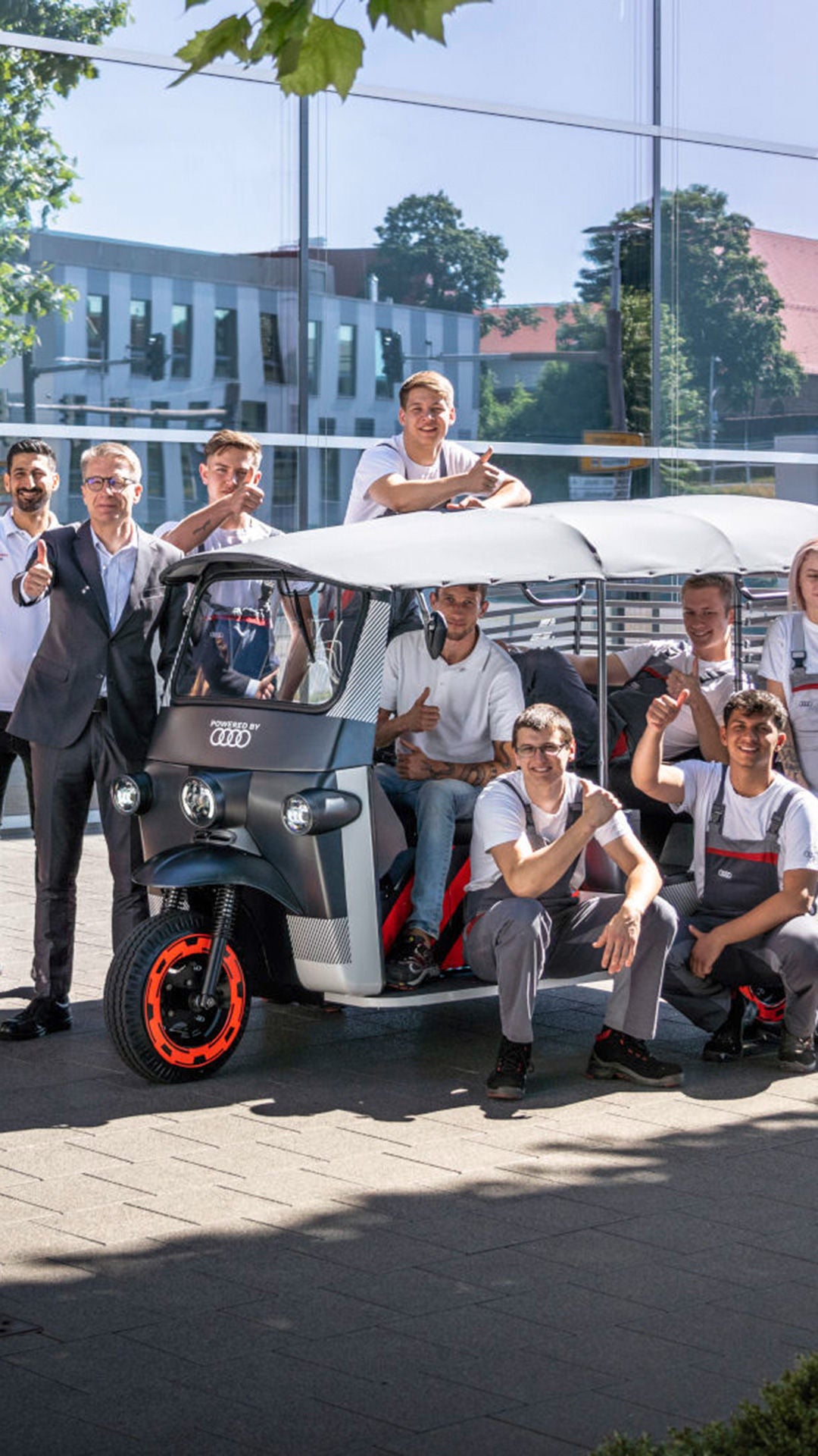 Woman in a white work coat looks into a bottle with a filling.