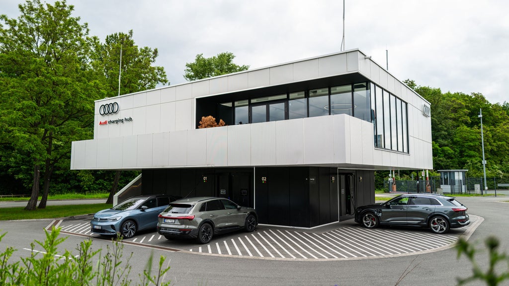 3 Audi cars stand around the Audi charging hub