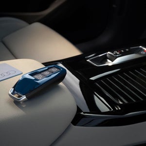 Audi key fob displayed inside the car, highlighting its sleek design and functionality.