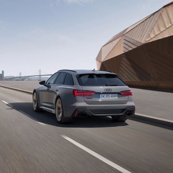 Audi RS 6 Avant performance moving along a racetrack.