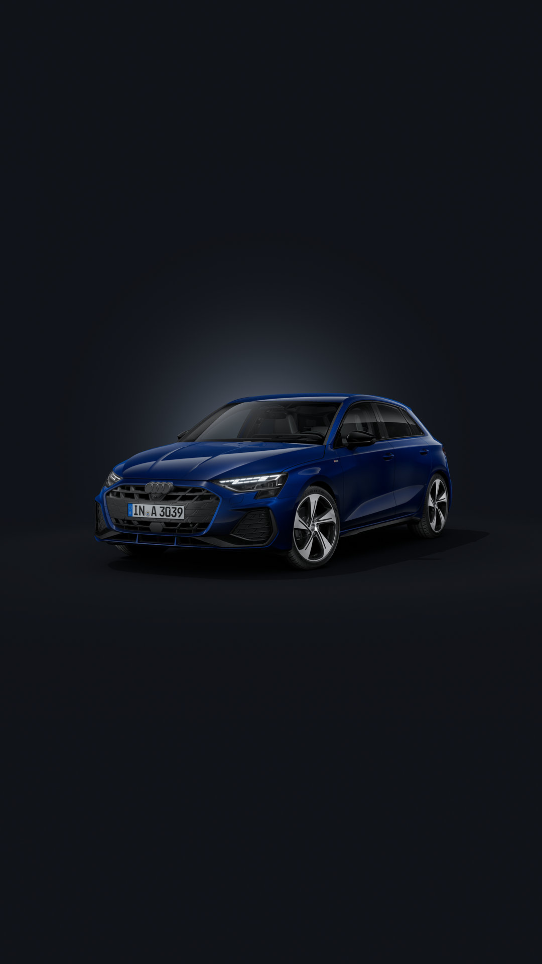 The Audi A3 Sportback, viewed from the front at an angle against a dark background.