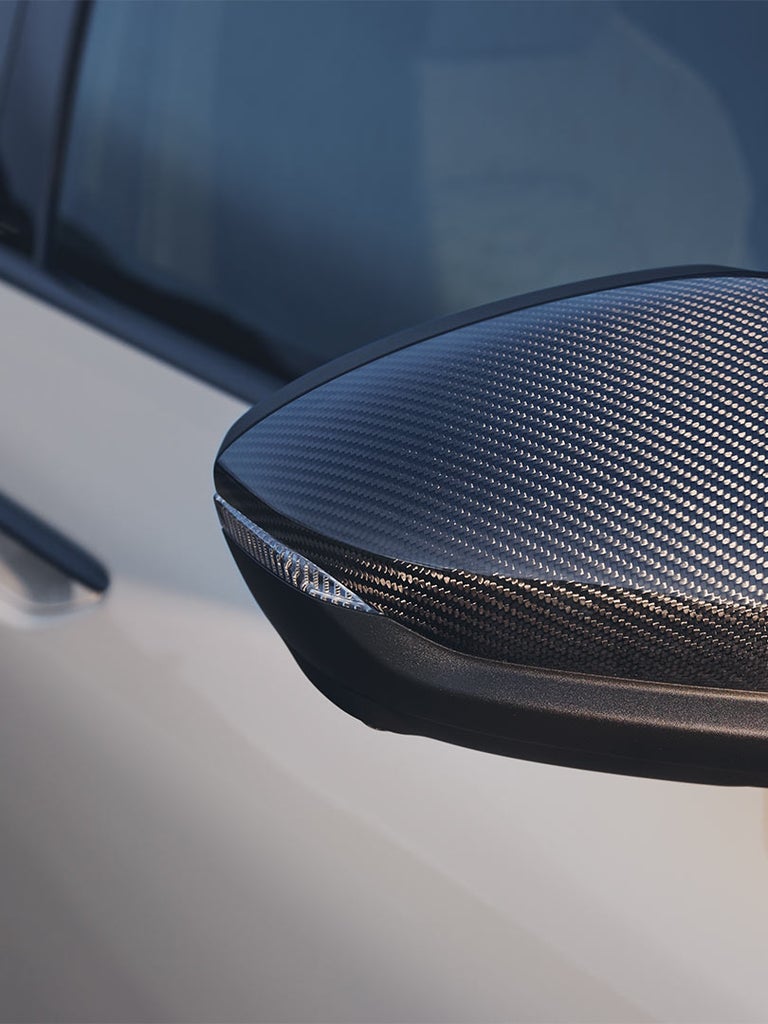 Nahaufnahme eines Seitenspiegels mit sportlicher Carbon-Optik.