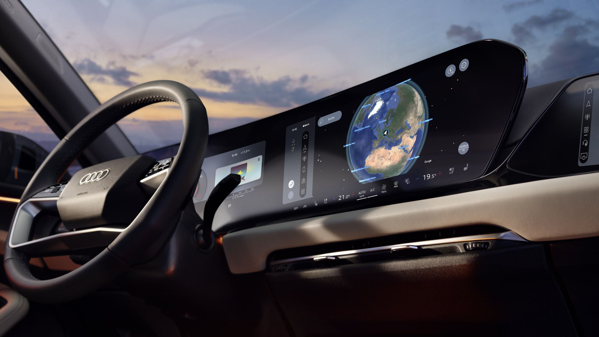 Blick ins Audi-Cockpit mit großem Display, das eine Globus-Navigation zeigt.