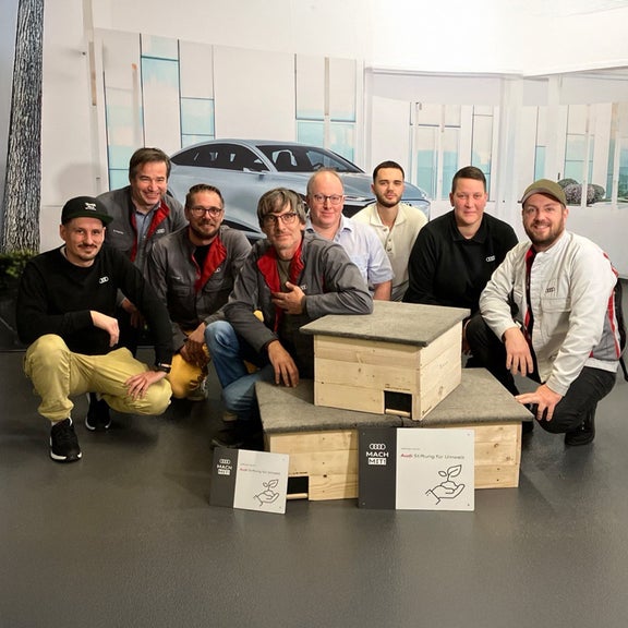 Group poses with hedgehog houses