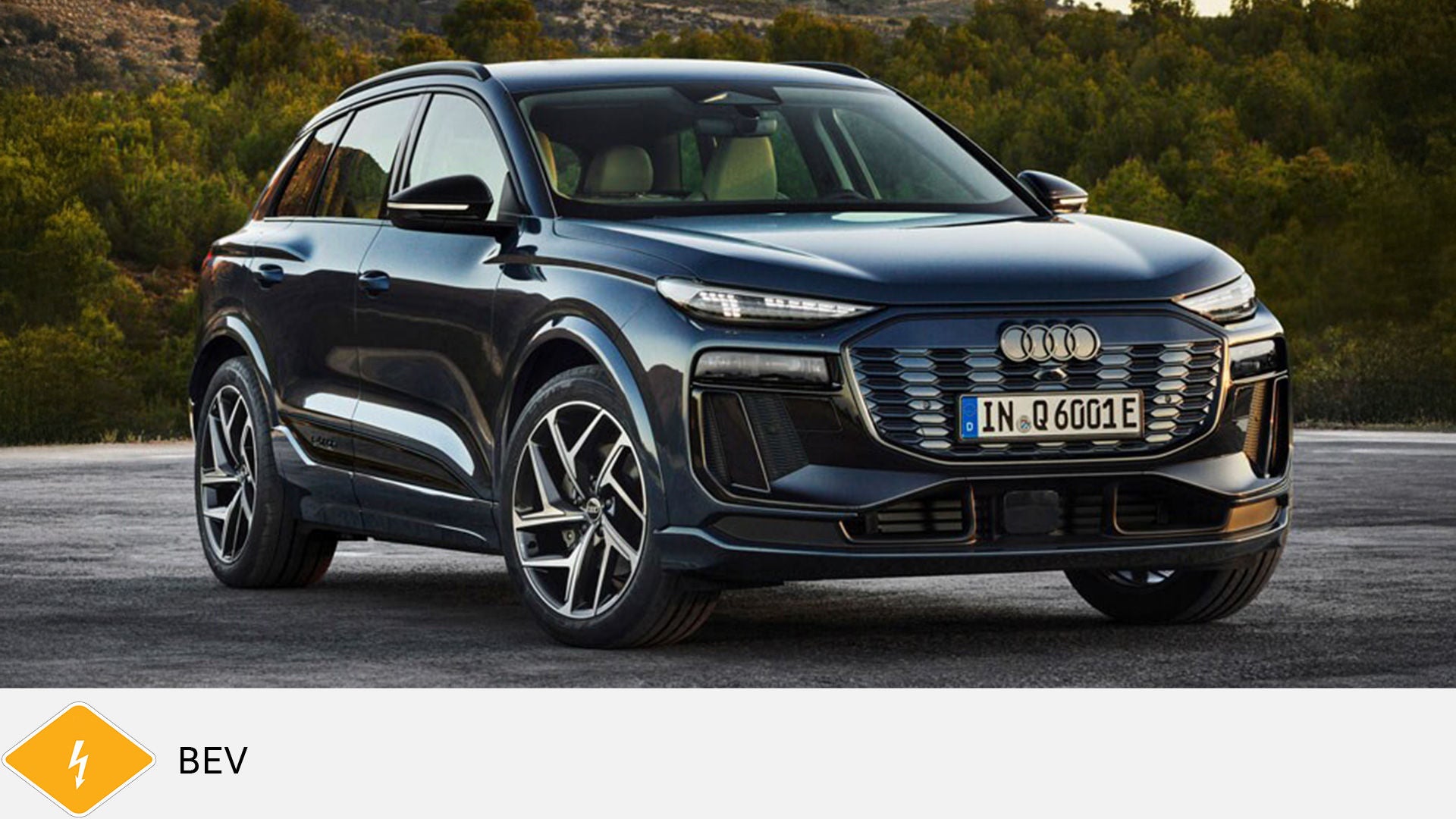 Dark blue Audi Q6 e-tron SUV parked on road in wooded area. Yellow BEV symbol with lightning bolt below.