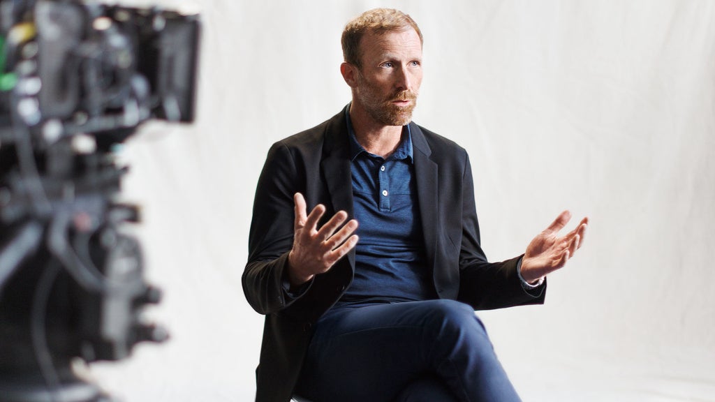 Spencer Reeder during a talk, gesticulating with his hands.