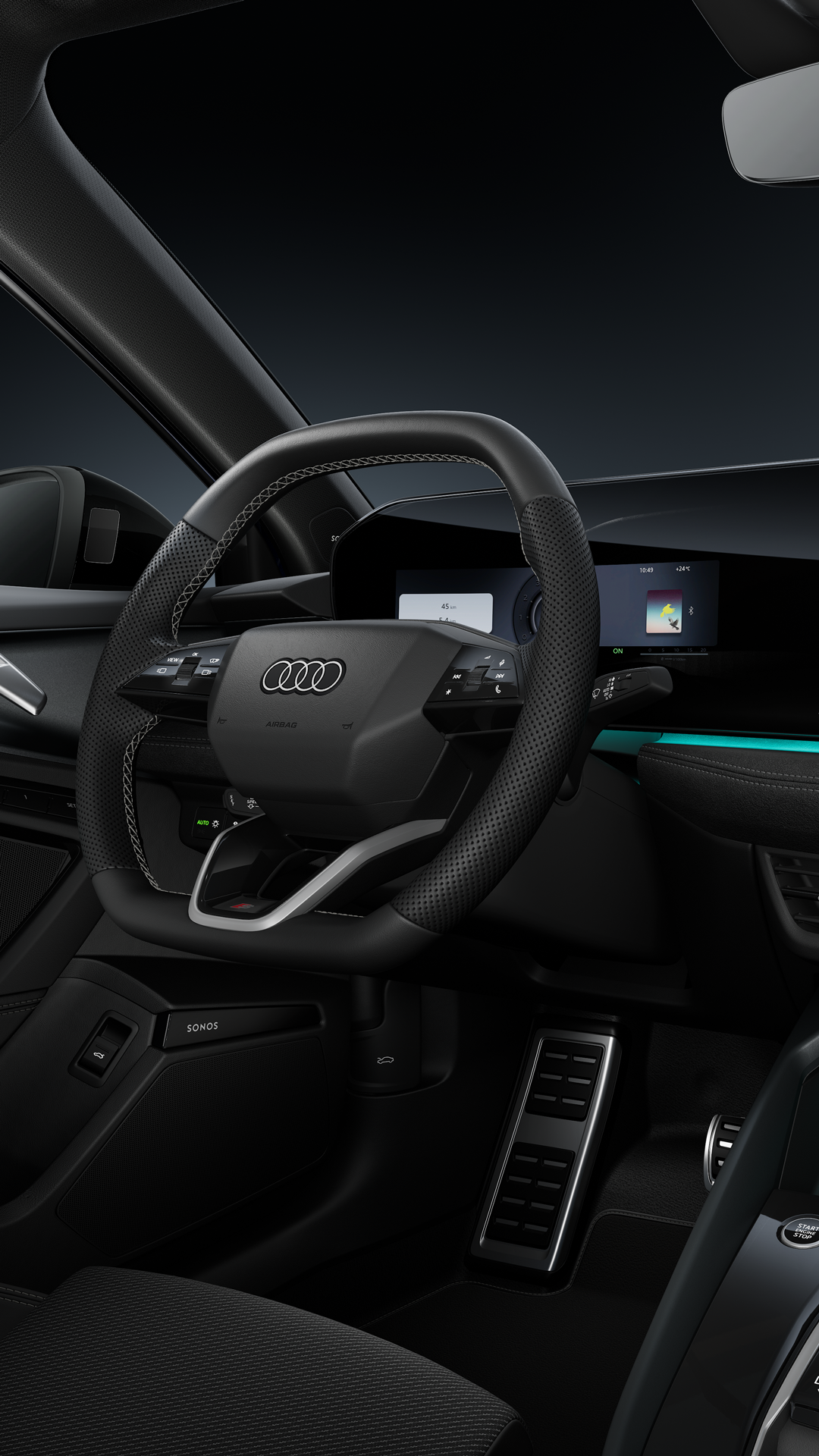 Seitlicher Blick auf das Cockpit mit Sportlenkrad, das geschwungene Panoramadisplay und das Ambiente-Licht.