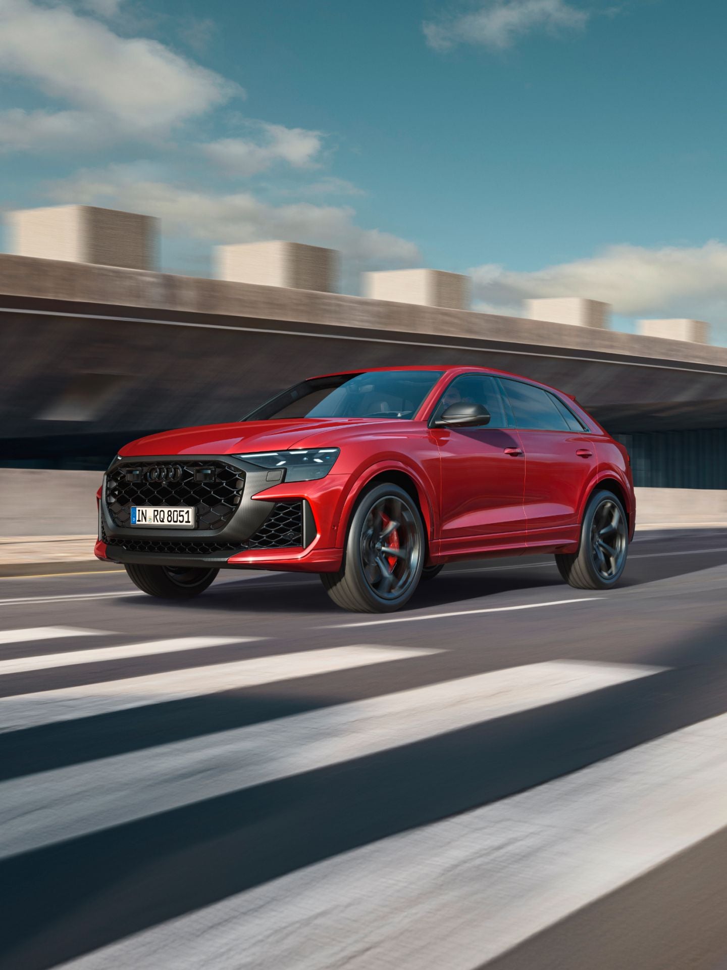 Red RS Q8 performance approaching a zebra crossing.