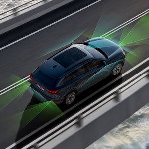 Audi Q6 e-tron widziane z góry pod kątem. Zielone i niebieskie wektory są widoczne za i przed pojazdem.