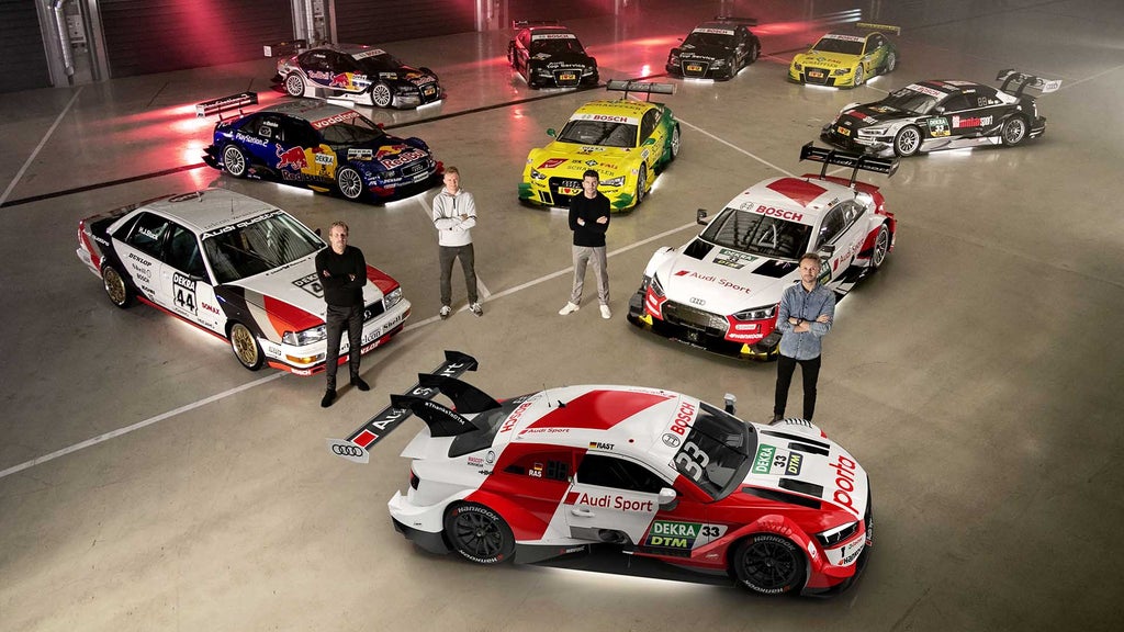 A group picture showing Audi race cars and drivers that won DTM titles, taken in Neuburg an der Donau.