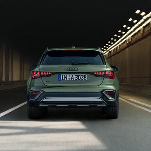 The Audi A3 allstreet is seen from behind as it drives through a tunnel.