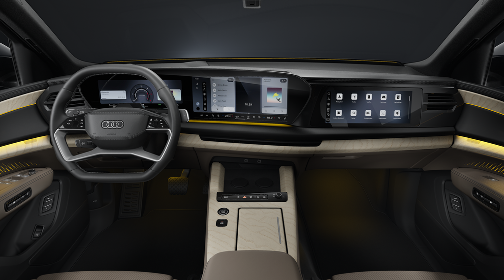 Blick von der Rückbank in das Cockpit des Audi Q9 SUV. Im Fokus das Lenkrad und die Panoramadisplays mit dem Audi Virtual Cockpit und dem MMI Display.