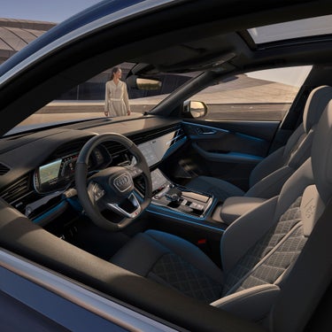 Internal view from driver side showing controls and display console in Audi SQ8.