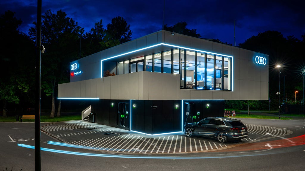 The illuminated Audi charging hub in Nuremberg at night