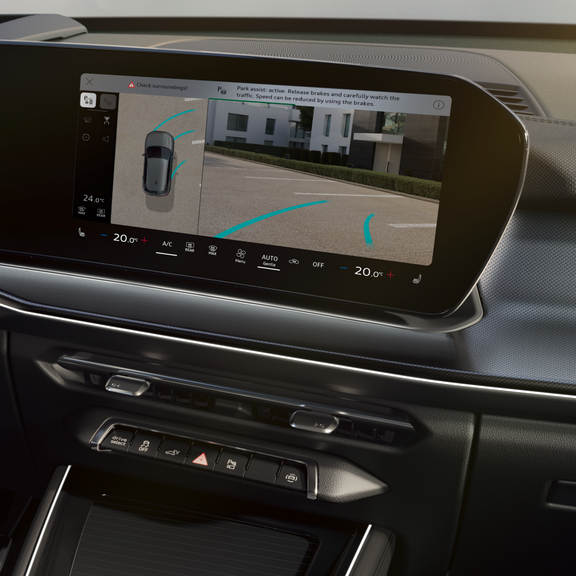 Close-up of the MMI display. The screen shows the image from the rear-view camera as the vehicle is being parked.