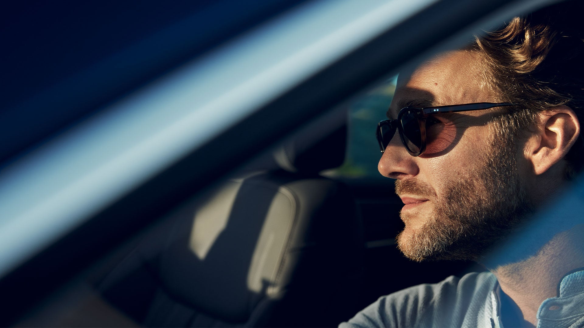 Side profile of man driving car wearing glasses - Target Market Determinations Hero Image