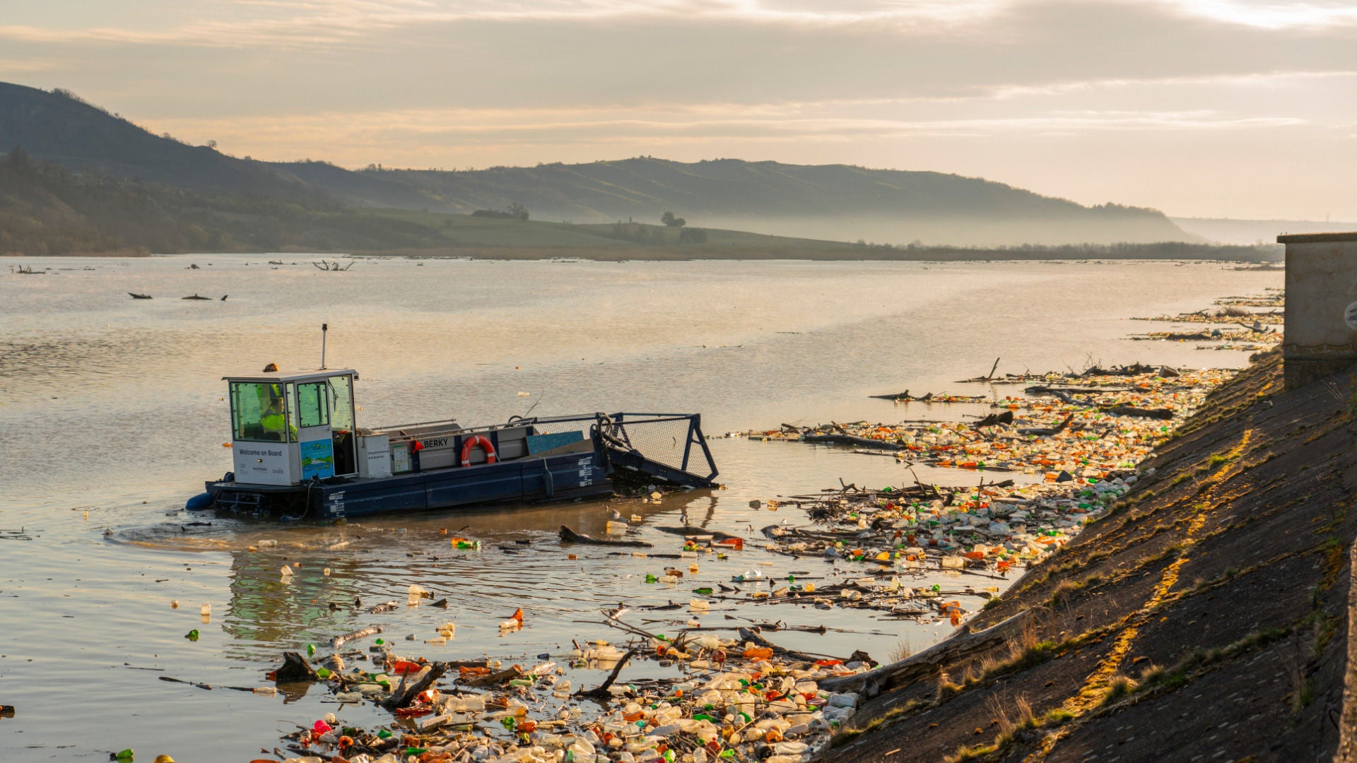 An e-rickshaw drives along a cobbled road lined with trees.