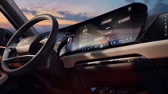 Interior of an Audi car with steering wheel and digital dashboard in view