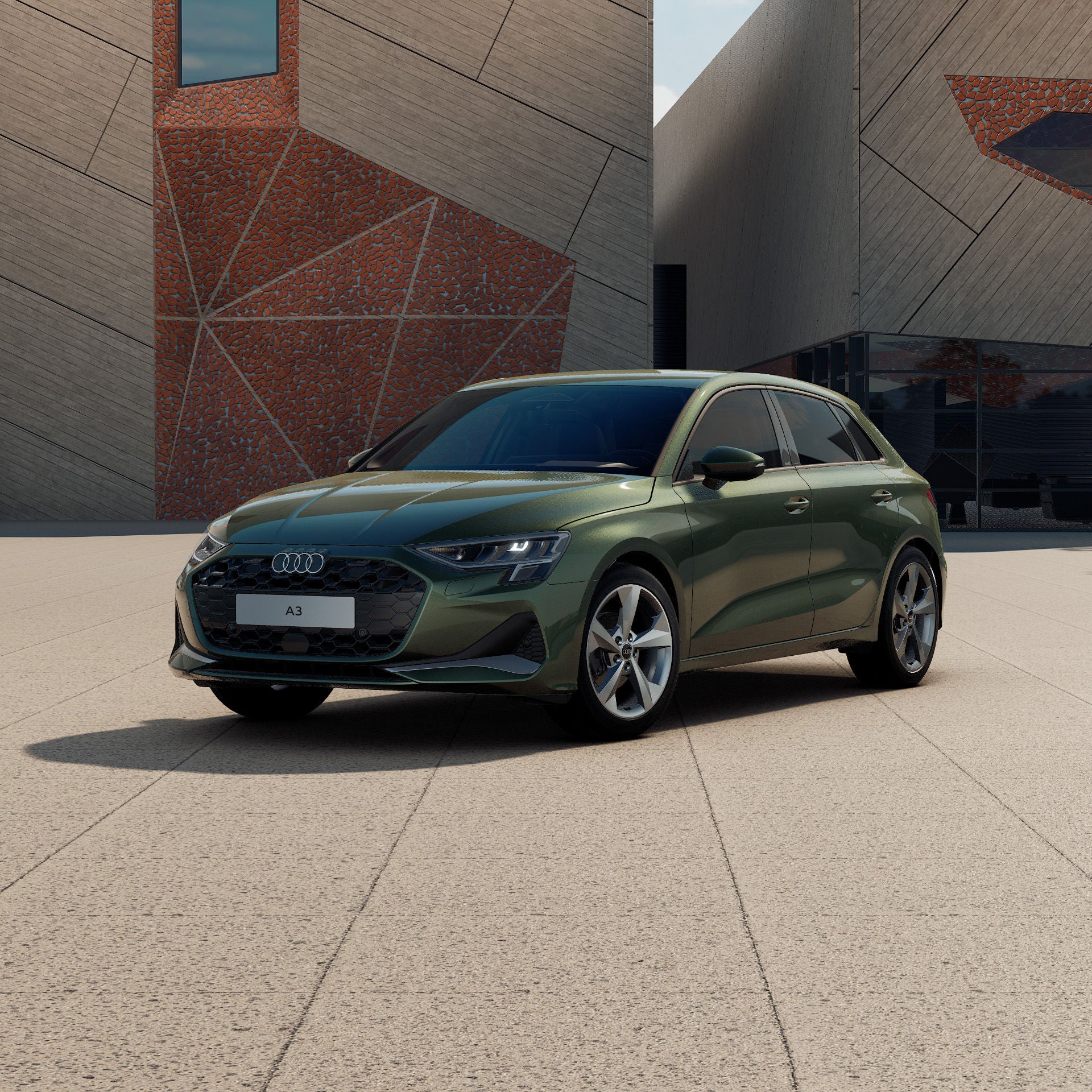 Grüner Audi A3 Sportback vor einem modernen Gebäude