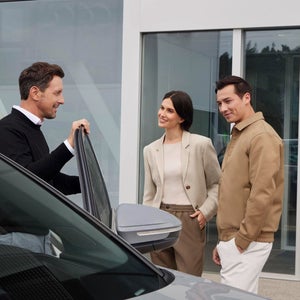 A man closely examining a car window