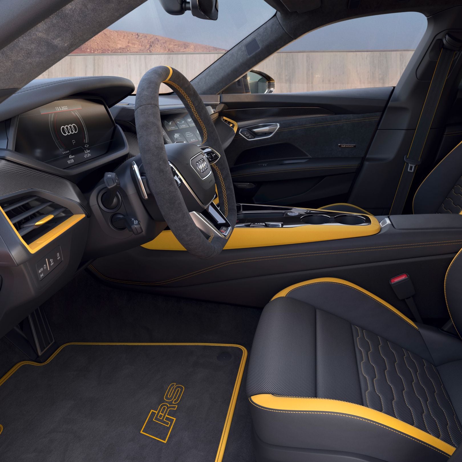 Interior of a car with black and yellow trim, steering wheel in focus.