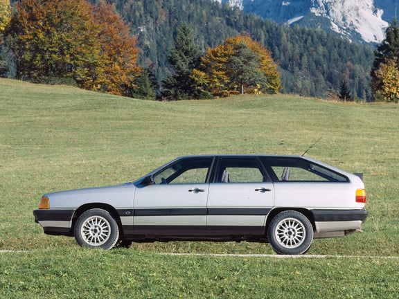 Photo of an Audi 100 Avant CS quattro in silver against a mountain backdrop