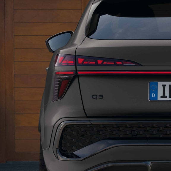 The Audi Q3 Sportback can be seen. It is a close-up of the rear, focusing on the OLED technology used in the rear lights.