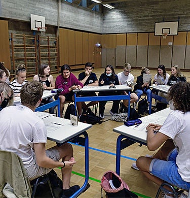 Students sitting in a circle, reenacting a climate conference