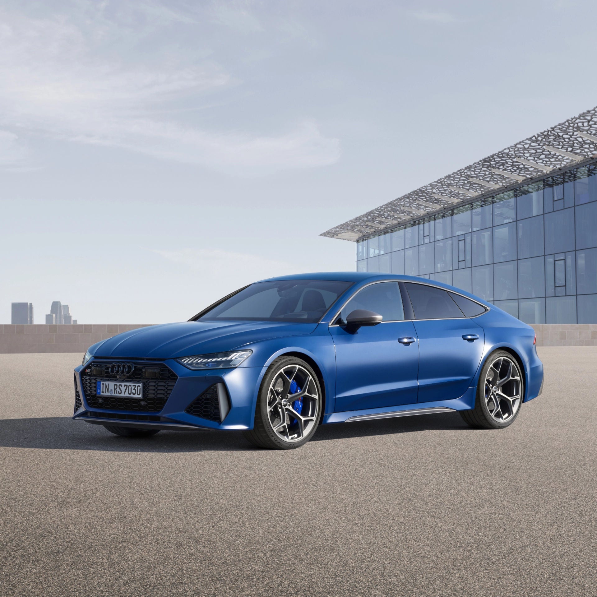 Blue RS 7 on a rooftop with city skyline background