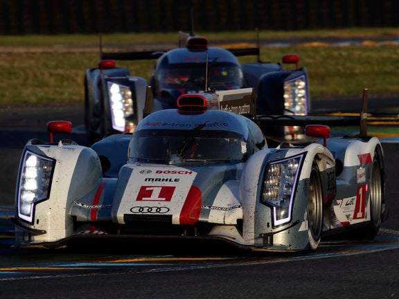 A picture showing the victorious Audi R18 e-tron quattro on track at Le Mans in 2012.