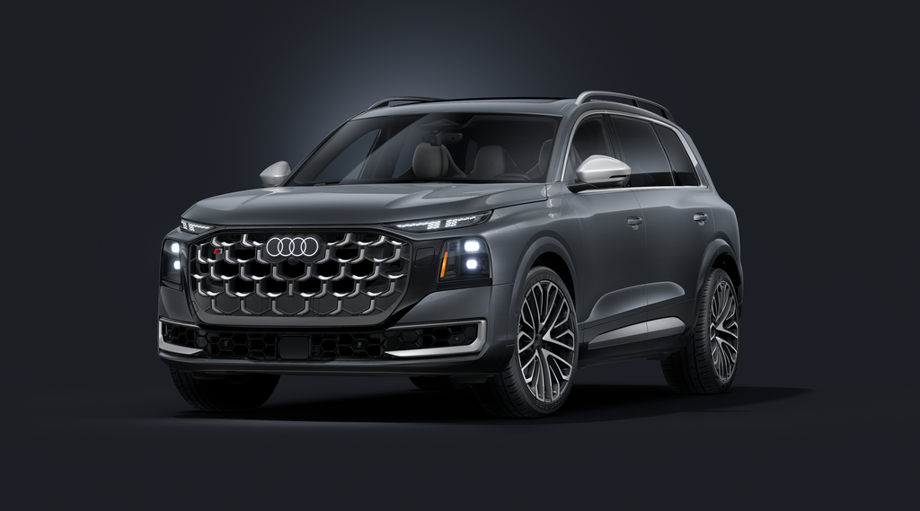 The Audi SQ9 SUV, viewed from the front at an angle against a dark background.