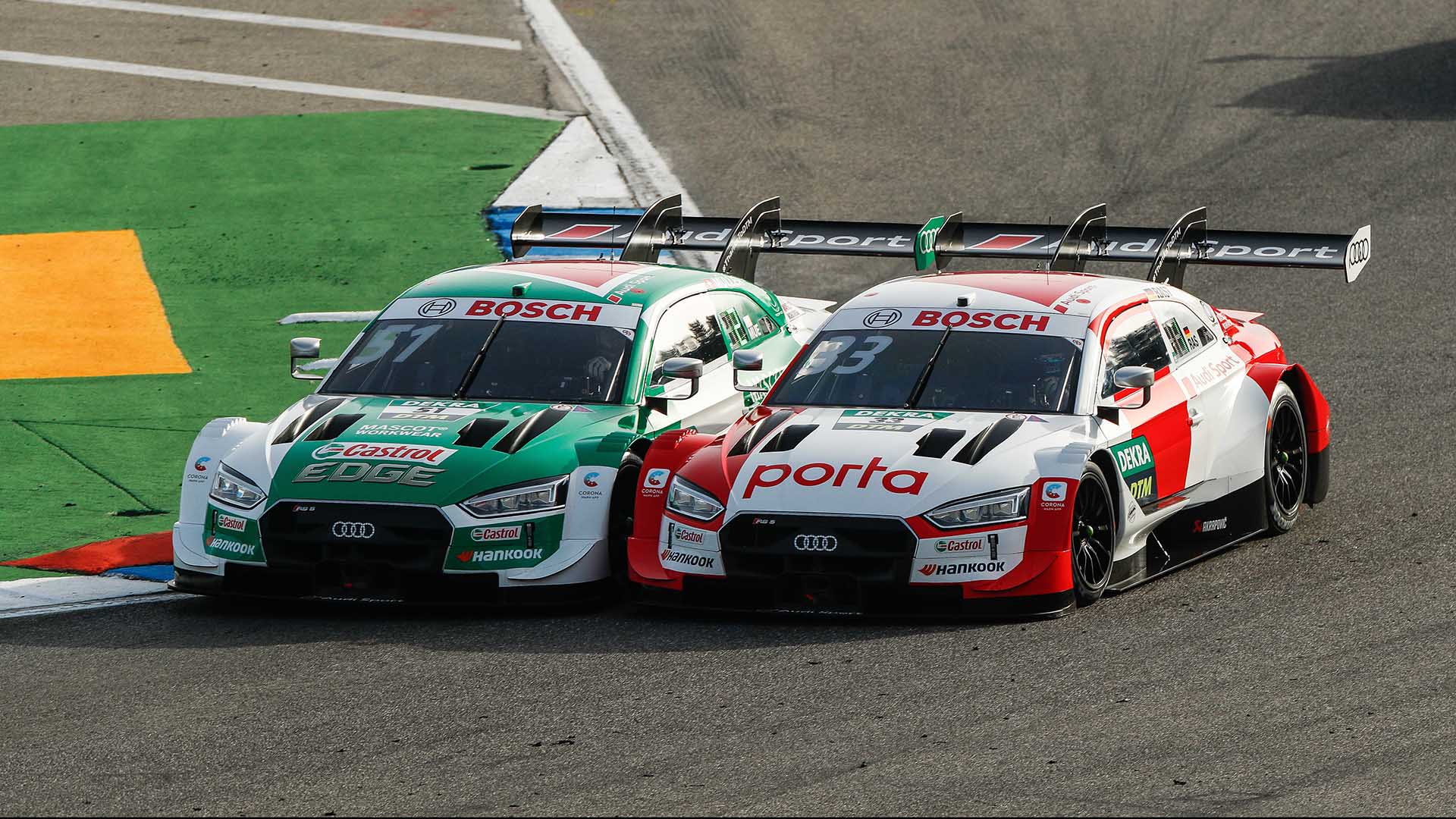 A picture showing the Audi RS 5 DTM race cars of Nico Müller and René Rast on track at Hockenheim in 2020.