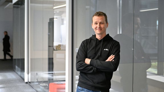 Alex, Office Lead SDC, looks into the camera with his arms crossed