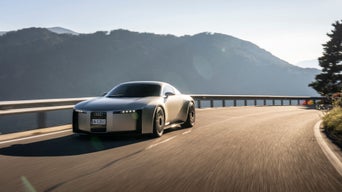 Audi C Concept drives on a road in a mountainous landscape