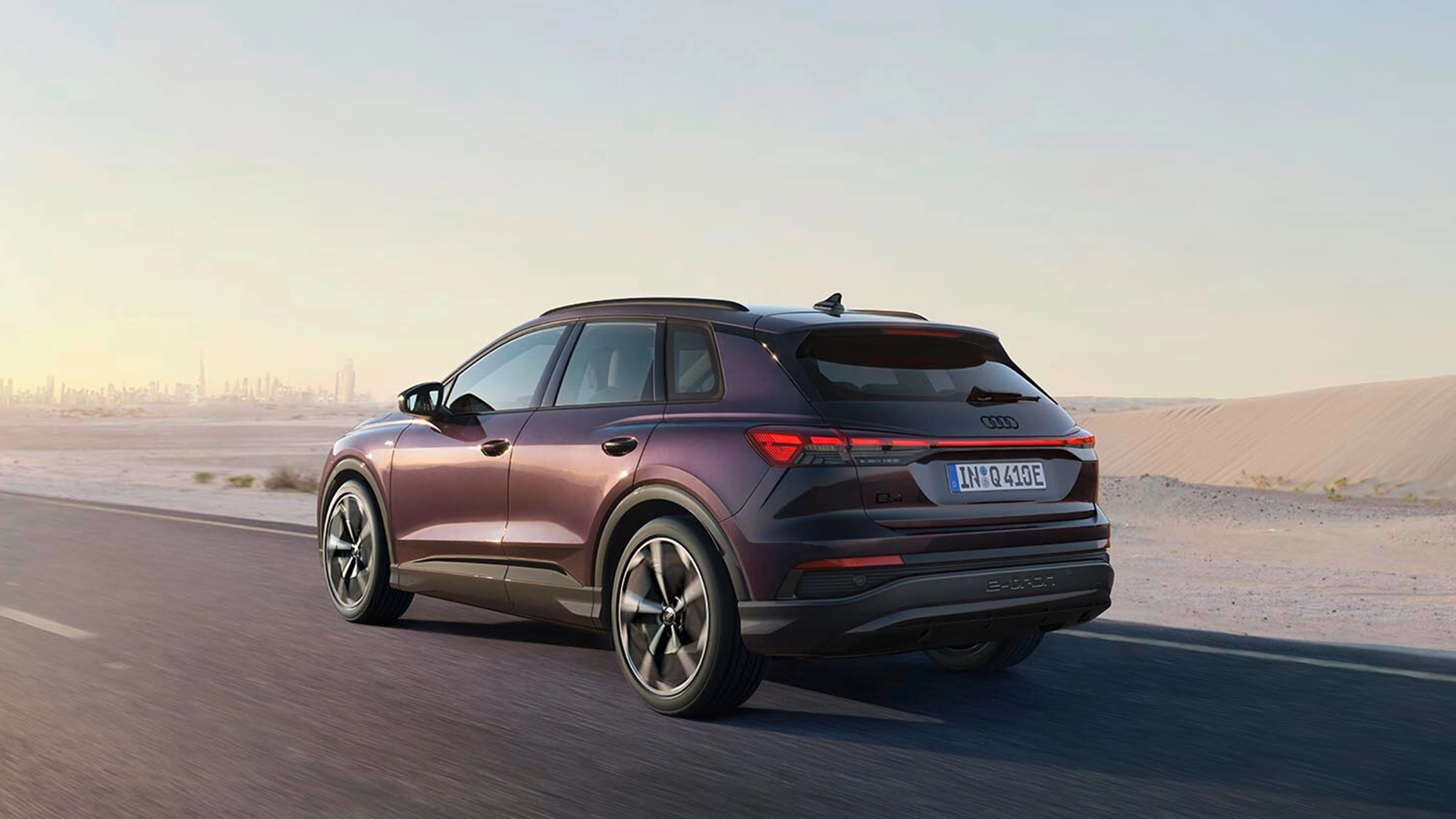 A charger plugging into a purple Audi Q4 SUV e-tron