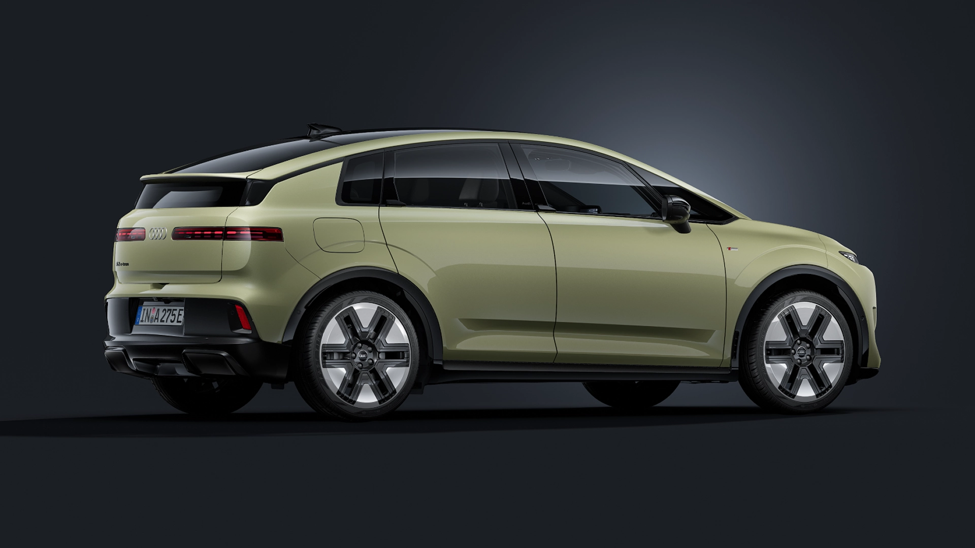 An Audi A2 e-tron electric crossover EV vehicle side profile against a dark studio background