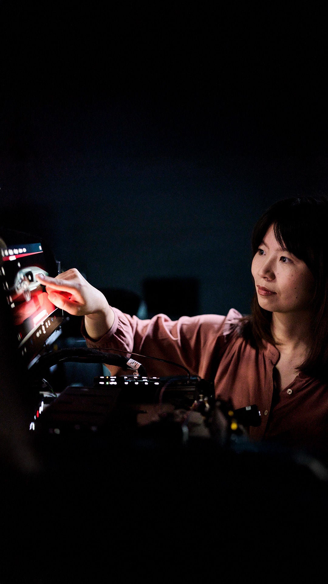 Melanie Schillinger clicks her finger on the screen of a device