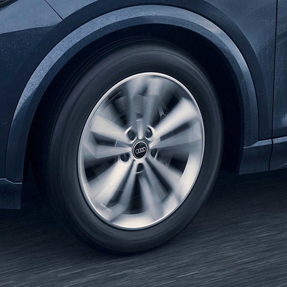Close-up of a spinning Audi wheel with sleek metallic spokes
