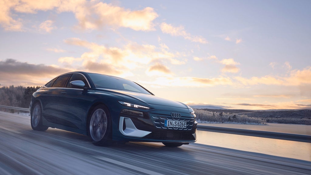 Black e-tron car on snowy road