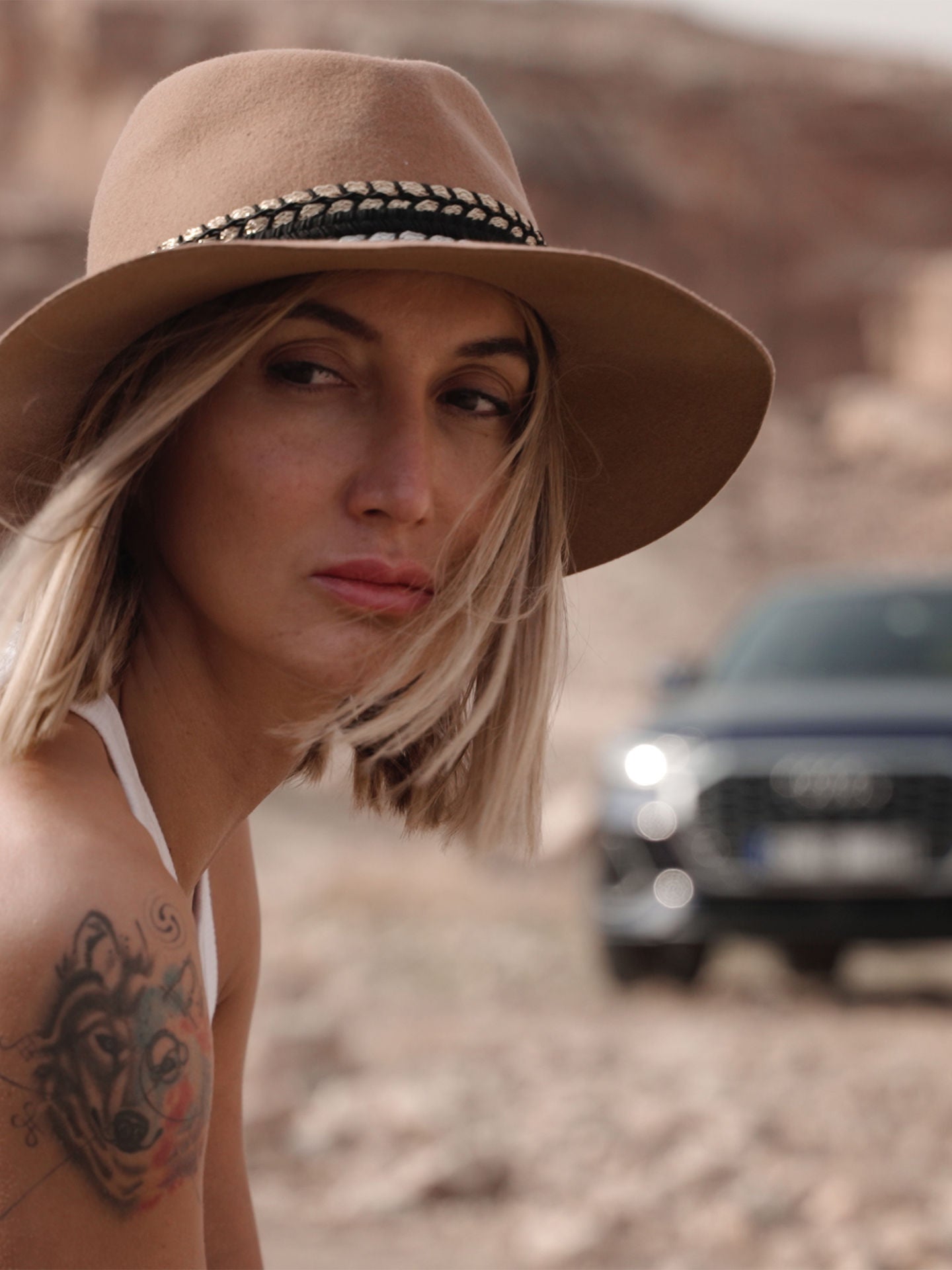 Audi RS e-tron GT sports car on a concrete surface in front of futuristic architecture