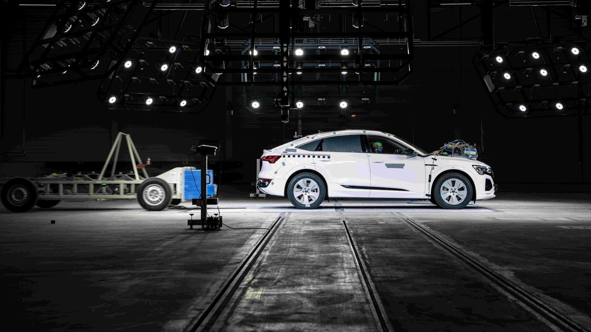 White Audi parked in a hall to carry out a crash test