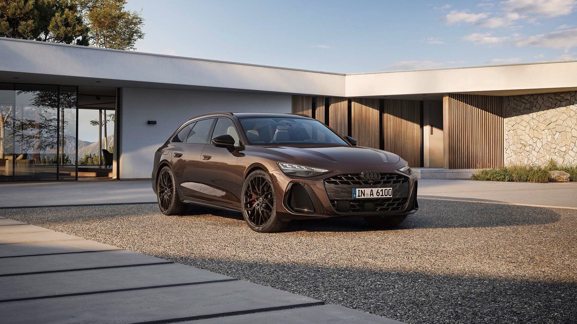The Audi A6 Avant parked outside a modern home