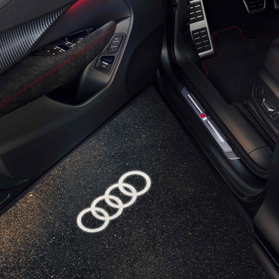 The Q3 Sportback with focus on the open door and entry LED, which projects the Audi rings with LED light onto the ground.
