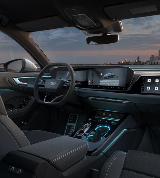 Uitzicht op de cockpit van de A5 Limousine e-hybrid.  Er zijn onder meer de panoramische displays en sfeerverlichting te zien.