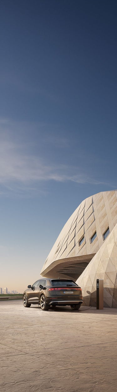 Audi Q8 SUV TFSI e rear view at the charging station