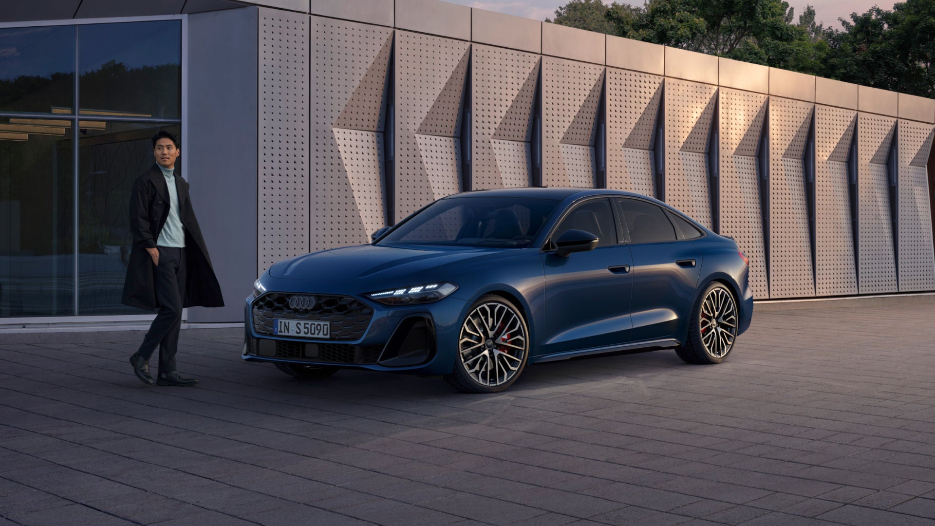 man walking towards an Audi S5