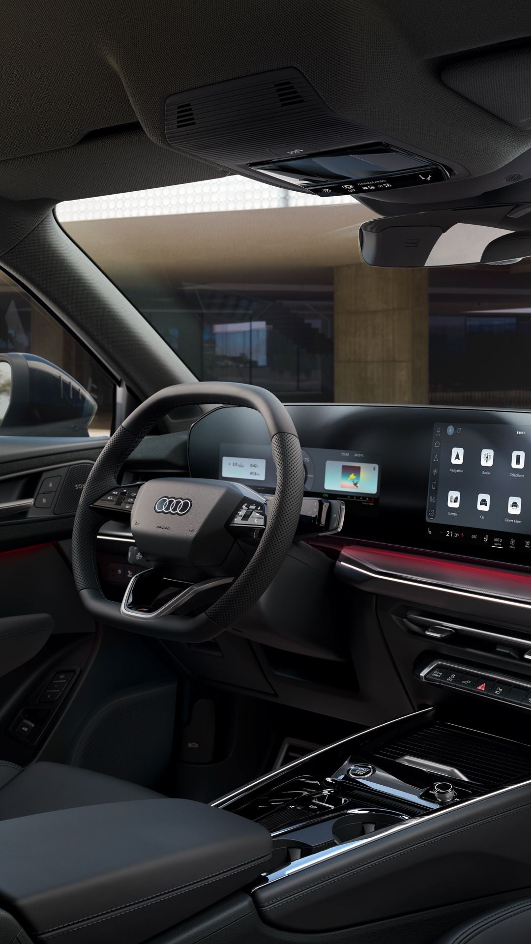 The interior of the Q3 Sportback e-hybrid with steering wheel, panoramic display, and red ambient lighting package.	